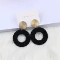 Bohemian geometric round drop earrings with textured gold studs and black woven design. - Black