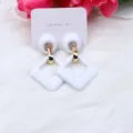 White acrylic geometric earrings with gold-tone metal connector, stylish modern design. - White