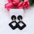 Black and gold geometric acrylic earrings with hollow diamond shape and delicate display card. - Black