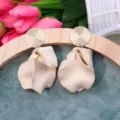 Chic cream petal drop earrings with textured gold round studs for women fashion accessories - Off White