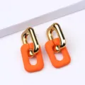 Boucles d'oreilles pendantes géométriques avec or poli et pendentif orange mat tendance. - Orange
