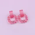 Pink acrylic earrings, translucent twisted square hoop design, stylish fashion jewelry piece. - Jelly Pink