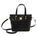 Black bucket bag with top handle and dog pendant, stylish leather crossbody shoulder bag. - Black