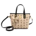 Chic beige bucket bag with black handle, bear print, and cute dog charm for women daily. - White