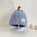 Detailed view of the cute blue baby knit pumpkin hat with stem and tag, soft winter toddler beanie. - Blue Pumpkin Hat