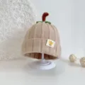 Close-up detail of cute baby knit pumpkin hat in beige, soft wool texture, kids winter cap - Beige Pumpkin Hat
