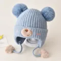 Cute baby winter knitted hat with double pom-poms and bear face design, light blue warm earflap cap. - One Size / Blue
