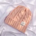 Pink cable knit beanie for women, warm thick winter cold hat with stylish woven label patch. - Light Pink