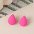 Close-up of bright pink teardrop acrylic stud earrings, simple and fresh design details. - Rose Red