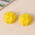 Detail view of yellow irregular geometric acrylic stud earrings, candy color design for women. - Yellow
