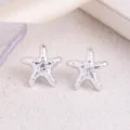 Silver starfish stud earrings with textured metallic finish detail close up display - Starfish / Silver