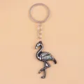 Close-up detail of the cute skeleton flamingo acrylic keychain pendant, smooth surface finish. - Skull Flamingo