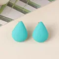 Close-up detail of turquoise teardrop acrylic stud earrings, minimalist chic jewelry. - Lake Blue