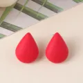 Close up view of vibrant red teardrop stud earrings, minimalist acrylic geometric jewelry - Red