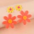 Colorful acrylic sunflower dangle earrings, exaggerated neon flower jewelry for women detail shot. - Orange