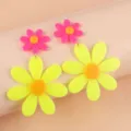 Close-up of vibrant neon pink and yellow acrylic flower earrings with a cute daisy design. - Fluorescent Yellow
