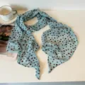 Close-up detail of light blue long silk scarf with brown polka dots, soft fabric texture. - Red Polka Dot Blue Silk Scarf