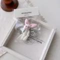 Cute plush bunny keychain with shiny silver wings and pearl pendant for bags and phone cases. - White Base Pink Ears Rabbit Wing Pendant