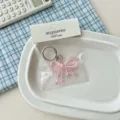 Portachiavi con fiocco rosa in acrilico trasparente ciondolo borsa accessorio carino 1pz - Rosa