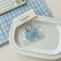 Portachiavi fiocco in acrilico blu, grazioso ciondolo per borsa, accessorio trasparente. - Blu