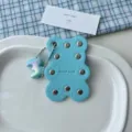 Cute blue leather bear keychain with metal rivets and colorful number pendant. - Blue