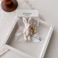 Plush bunny keychain with angel wings and pearls, cute bag charm and phone pendant accessory. - Beige Rabbit Wing Pendant