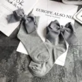 Grey cotton socks detail showcasing large striped ribbon bow and cute rolled cuff design. - One Size / Light Gray + Gray Bowknot
