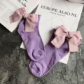 Detail view of cute purple student cotton socks featuring a large pink bow and rolled edge design. - One Size / Light Purple + Pink Bowknot