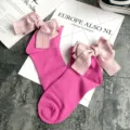 Detailed shot of cute pink cotton socks featuring large striped ribbon bows for sweet style. - One Size / Rose Red + Pink Bowknot