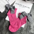 Pink cotton socks detail, featuring a large grey bowknot and rolled cuff design on flatlay surface. - One Size / Rose Red + Gray Bowknot
