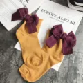 Cute Japanese style cotton socks for women, featuring a large bow and roll cuff design. - One Size / Ginger Yellow + Red Bowknot