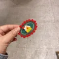 Handmade crochet hair clip with cute house design, red and green knit winter hair accessory. - Red Edge Green Base with Yellow House