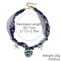 Blue paisley fabric choker necklace with multi-element metal charms and gold extension chain. - Blue Island Banana Shadow (N2510-5)
