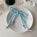 Cute blue woven bow keychain with colorful beads, dopamine style bag charm accessory. - Light Blue