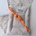 Handmade woven orange letter lanyard with beige canvas pouch, stylish ins phone charm. - Orange