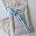 Handmade blue braided rope bag charm with letter beads and fabric pad for stylish decor. - Light Blue