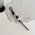 Woven bag charm strap with black and white acrylic letter beads spelling love design. - Black LOVE