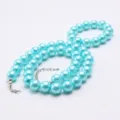 Bright blue faux pearl necklace detail, smooth round beads with secure silver clasp, elegant. - Bright Blue