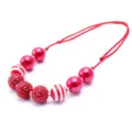 Detailed view of children's beaded necklace with resin rhinestone and striped balls. - Red