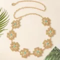 Close-up detail of vintage gold-tone metal waist chain featuring ornate cross plaques and turquoise. - Cross Turquoise Waist Chain / Gold