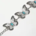 Gedetailleerd overzicht van de zilveren metalen tailleriem met stijlvolle vlinderschakels. - Zilver Turkoois Tailleketting