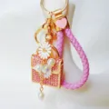 Cute rhinestone daisy handbag keychain with pink braided strap and pearls. Detail view. - Daisy Handbag Pink + Heart Lanyard