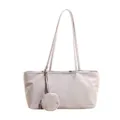 Close-up view of smooth nylon fabric texture and delicate stitching detail on this minimalist bag. - White