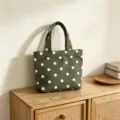 Detail view of a green canvas polka dot tote bag, elegant design for casual daily use. - Green