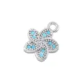 Detailed view of the five-petal flower pendant with turquoise stones and shimmering pavé. - Platinum Turquoise