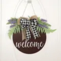 Rustic wooden welcome door sign with artificial lavender, green fern leaves, and plaid bow. - Plaid Door Hanging / 40CM
