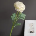 Detailed close-up of artificial ranunculus flower with realistic green leaves and delicate petals. - White (1#)