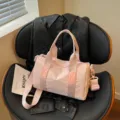 Stylish pink travel duffel bag for women, lightweight casual crossbody and shoulder bag. - Pink