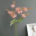 Close-up detail of artificial pink wild bamboo flowers with green leaves for home decoration. - Champagne