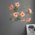 Detailed shot of artificial wild rose stem with delicate cream pink petals and green leaves. - H64CM / Orange